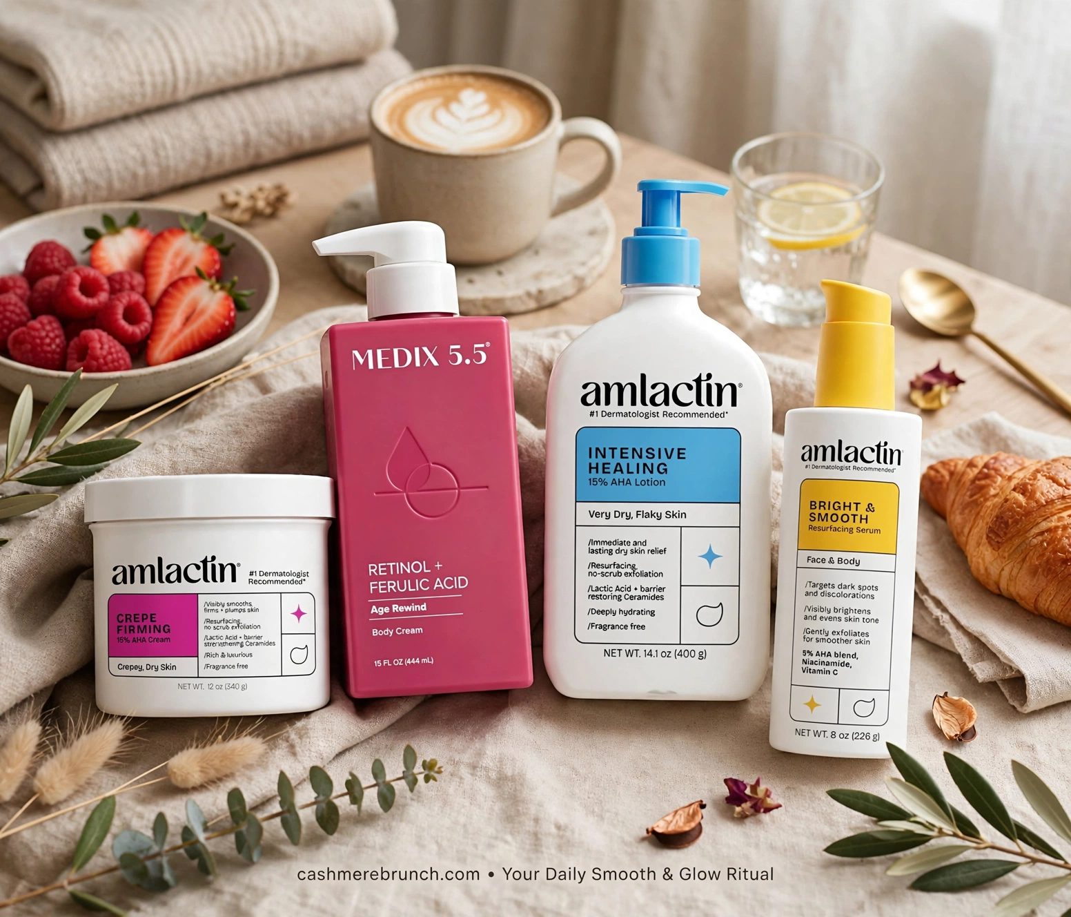 AmLactin Crepe Firming cream, MEDIX 5.5 Retinol + Ferulic Acid body cream, AmLactin Intensive Healing lotion and AmLactin Bright & Smooth serum on a linen tablecloth, beside a latte, a bowl of berries and a croissant.